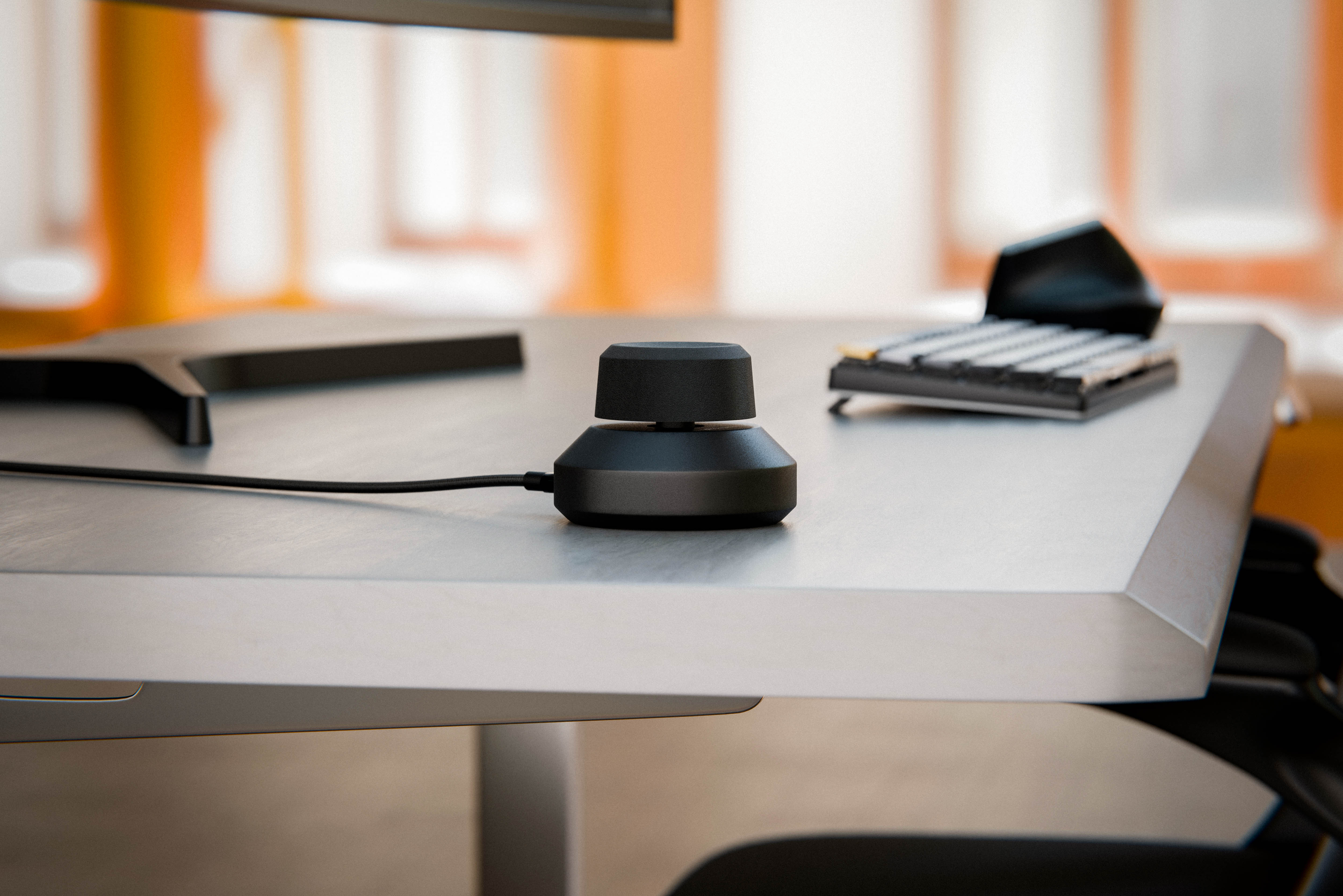 Orbit on a desk beside a keyboard and mouse
